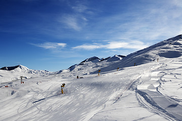 Image showing Ski slope with snowmaking at sun morning