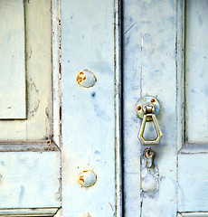 Image showing abstract cross   brass brown knocker in   venegono  varese italy