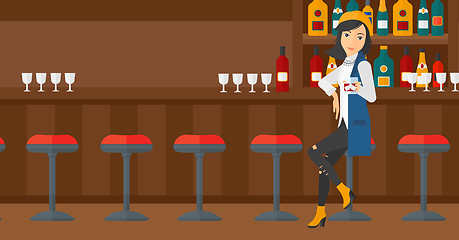 Image showing Woman sitting at bar.