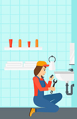 Image showing Woman repairing sink.