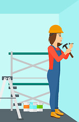 Image showing Constructor hammering nail.