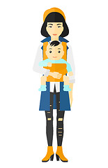 Image showing Woman holding baby in sling.