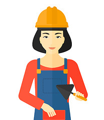 Image showing Bricklayer with spatula and brick.