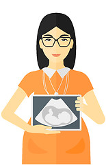 Image showing Pregnant woman with ultrasound image.