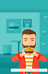 Image showing Man eating hamburger. 