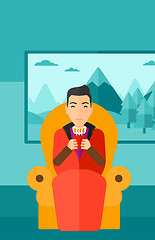 Image showing Man sitting in chair with cup of tea.