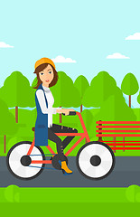 Image showing Woman riding bicycle.