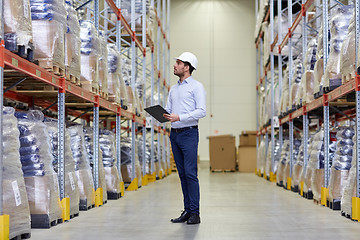 Image showing happy businessman with clipboard at warehouse