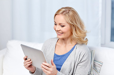 Image showing happy middle aged woman with tablet pc at home