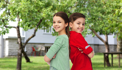 Image showing happy boy and girl standing together over backyard