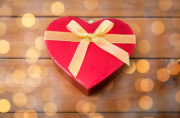 Image showing close up of heart shaped gift box on wood