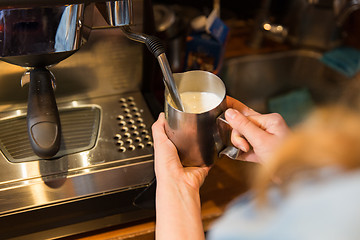 Image showing close up of woman making coffee by machine at cafe