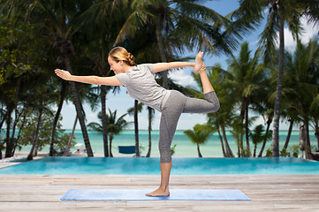 Image showing woman making yoga in lord of the dance pose on mat