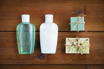 Image showing close up of handmade soap bars and lotions on wood