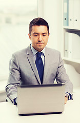 Image showing businessman working with laptop in office