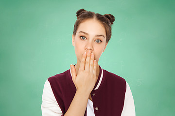 Image showing confused teenage student girl covering her mouth