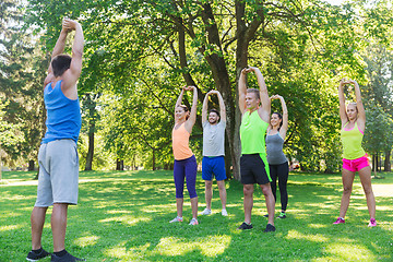 Image showing group of friends or sportsmen exercising outdoors