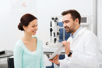 Image showing optician with tablet pc and patient at eye clinic