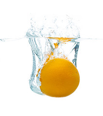 Image showing orange falling or dipping in water with splash