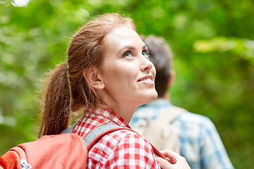 Image showing group of smiling friends with backpacks hiking