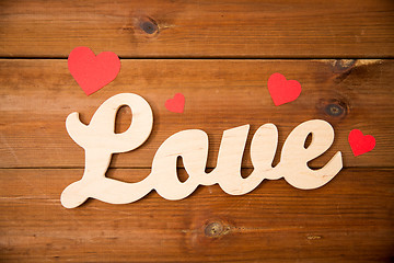 Image showing close up of word love with red paper hearts