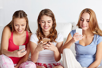 Image showing friends or teen girls with smartphone at home