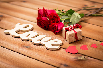 Image showing close up of gift, word love, red roses and hearts