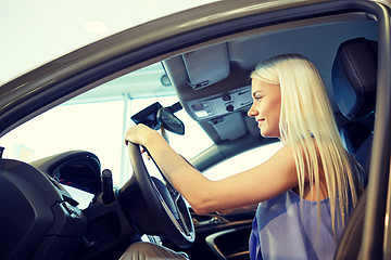 Image showing happy woman inside car in auto show or salon