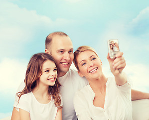 Image showing happy family with camera at home