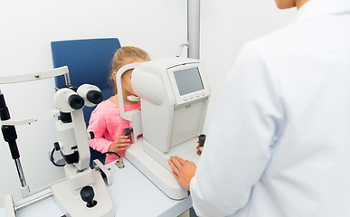 Image showing optician with autorefractor and kid at eye clinic