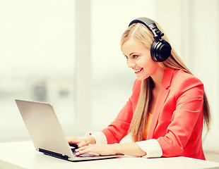 Image showing happy woman with headphones listening to music