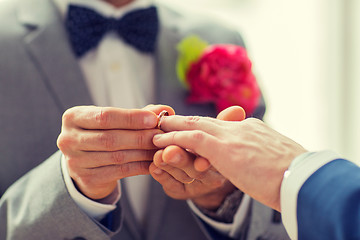 Image showing close up of male gay couple hands and wedding ring