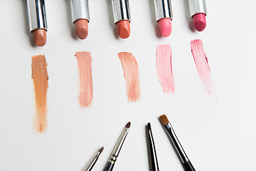 Image showing close up of lipsticks range with makeup brushes