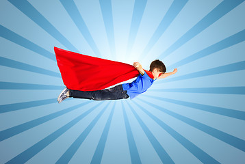 Image showing boy in red superhero cape and mask flying on air