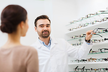 Image showing woman and optician showing glasses at optics store