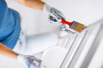 Image showing woman with paintbrush and paint pot