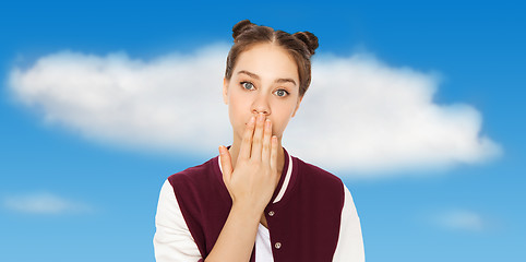 Image showing confused teenage girl covering her mouth by hand