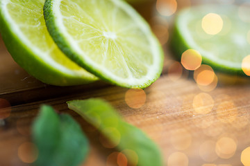 Image showing lime slices on wooden table