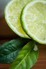 Image showing lime slices on wooden table