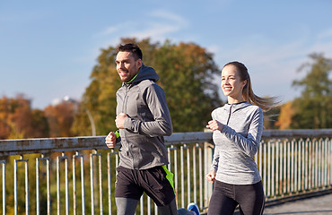 Image showing happy couple running outdoors