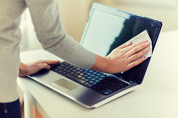 Image showing close up of woman hands cleaning laptop screen