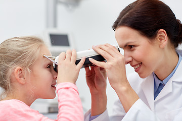 Image showing optician with pupilometer and patient at eye clinic