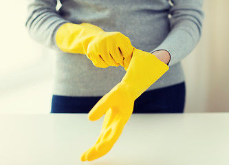 Image showing close up of woman wearing protective rubber gloves