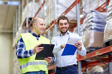 Image showing worker and businessmen with clipboard at warehouse