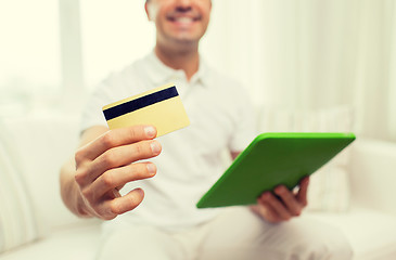 Image showing close up of man with credit card and tablet pc