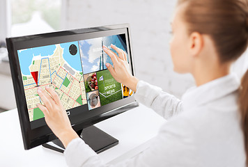 Image showing businesswoman with computer touchscreen in office