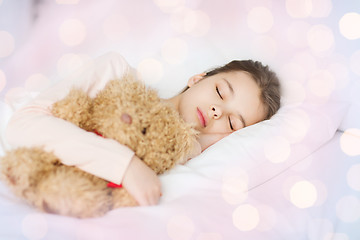 Image showing girl sleeping with teddy bear toy in bed at home