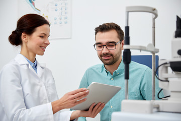 Image showing optician with tablet pc and patient at eye clinic