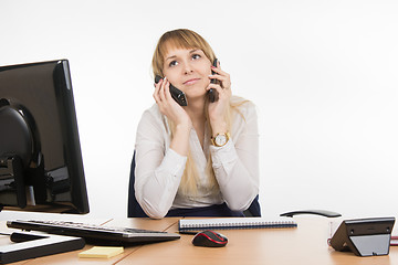 Image showing Secretary talking on two phones at once - and the working cell