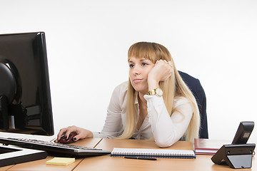 Image showing Office worker looking blankly at the computer screen in the office